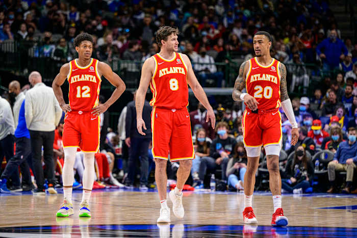 Feb 6, 2022; Dallas, Texas, USA; Atlanta Hawks forward De'Andre Hunter (12) and forward Danilo Gallinari (8) and forward John Collins (20) walk back on to the court during the second half against the Dallas Mavericks at the American Airlines Center.
